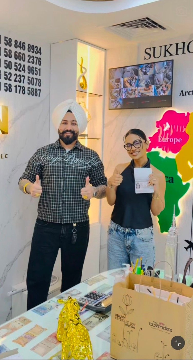Sukhchain Travel client with passport at our office